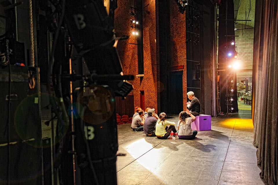 Professor Robert Walsh teaching students on stage