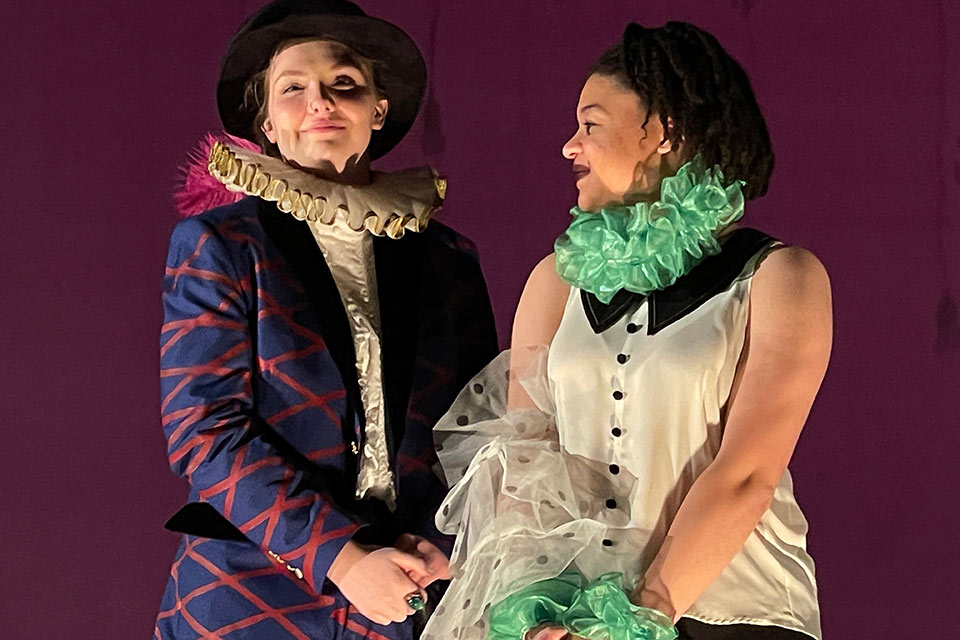 Two actors in costume on stage