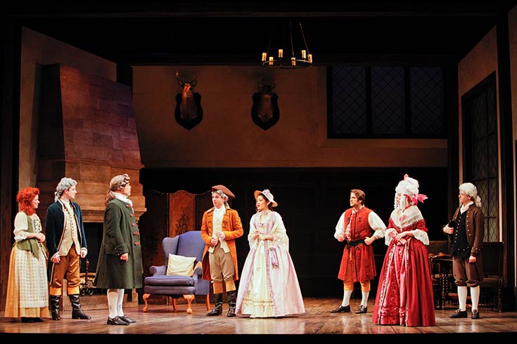 Two male actors in period costumes performing She Stoops to Conquer