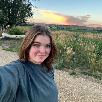 liza heck smiling outdoors