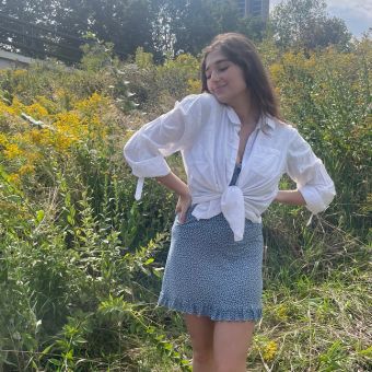 rachel poses near flowers