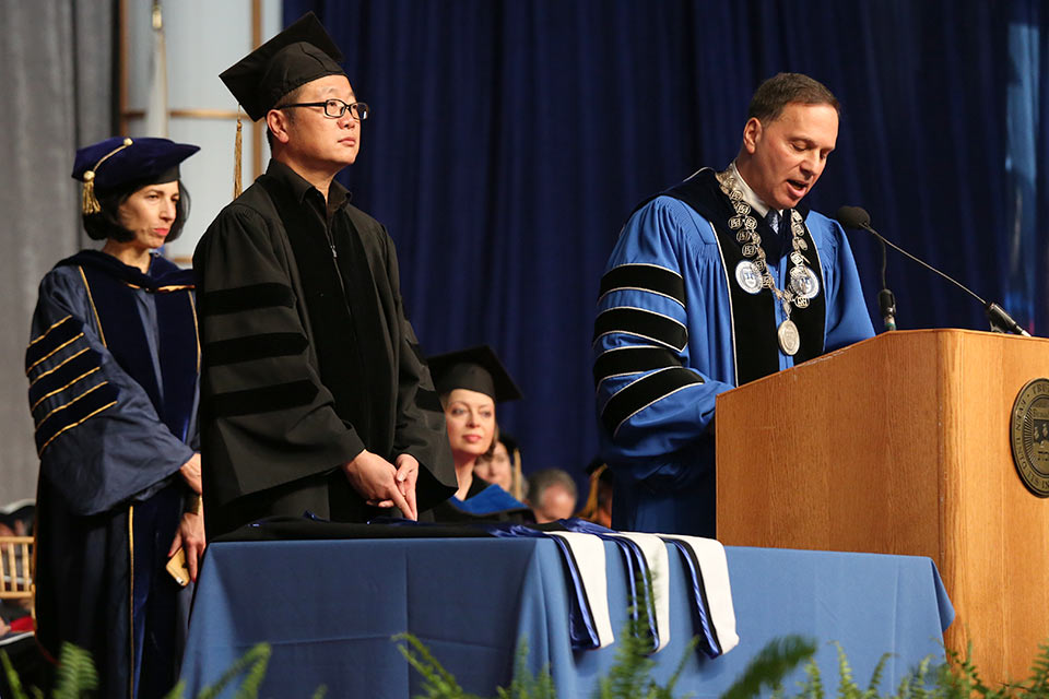Cixin Liu is is presented with an honorary degree at the 2019 Commencement Ceremony