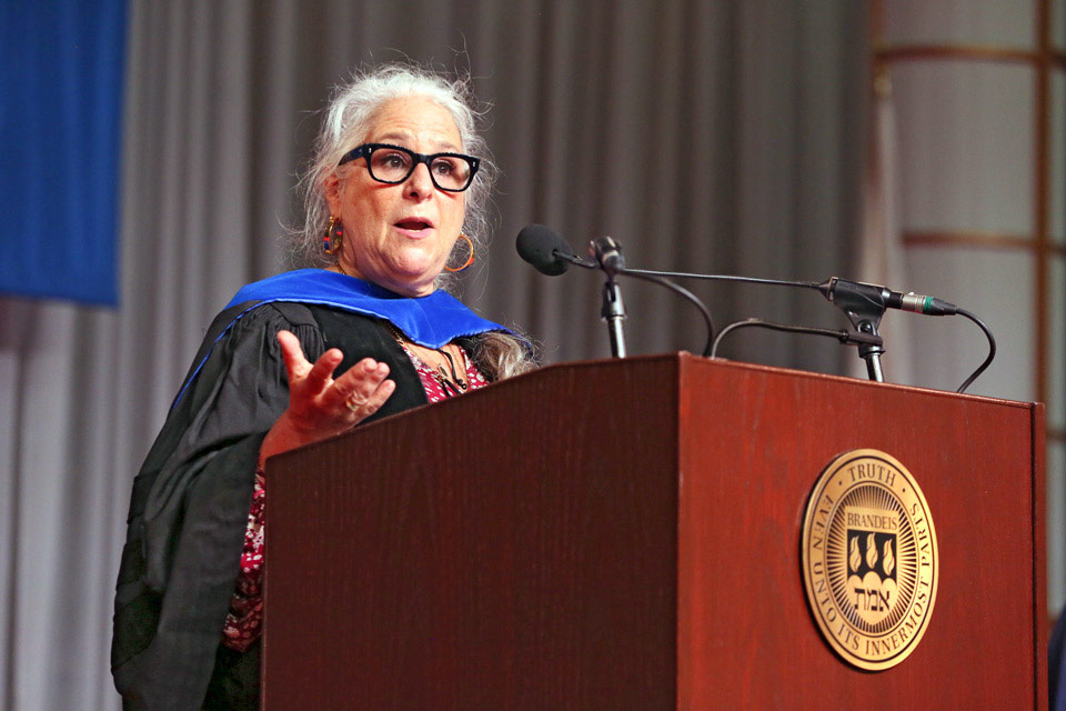 Marta Kauffman speaking at a podium at [Re]Commencement