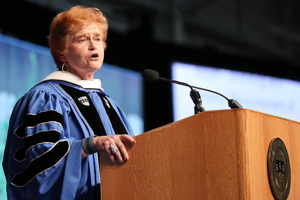 Barbara Lipstadt speaking at a podium at Commencement