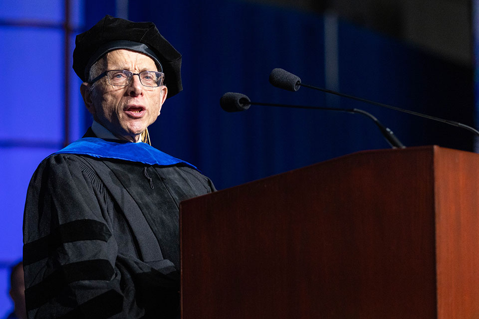 Jonathan D. Sarna speaking at a podium at the undergraduate Commencement ceremony.