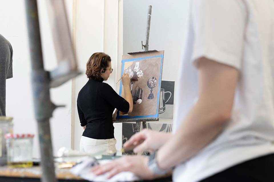 A student painting in an art class