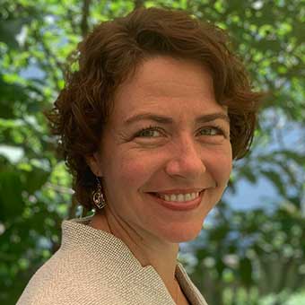 Sabine has short blonde hair and glasses