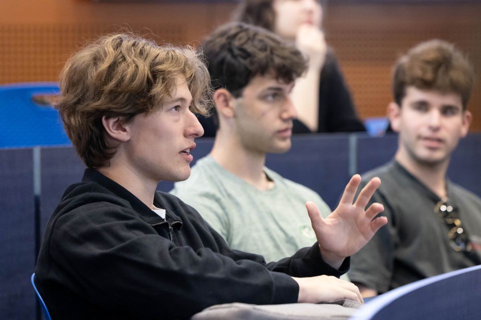 student raising hand in class