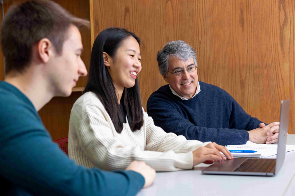 students studying with a professor