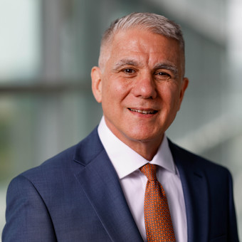 Jeffrey Shoulson has short grey hair and wears a blue suit.