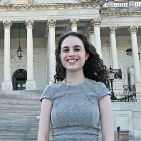 Mandy stands in front of a capitol building