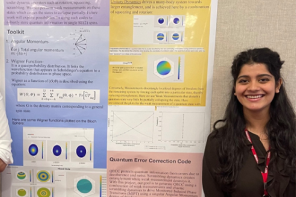 Srishti stands with her poster presentation