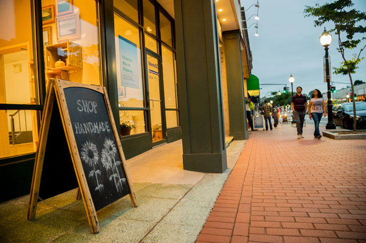 A chalkboard sign on a street that says "Shop homemade"