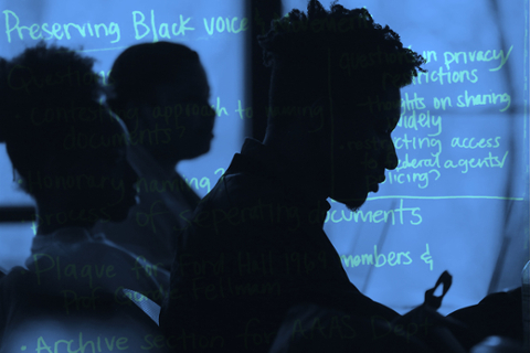 Silhouette of students in front of computer screen