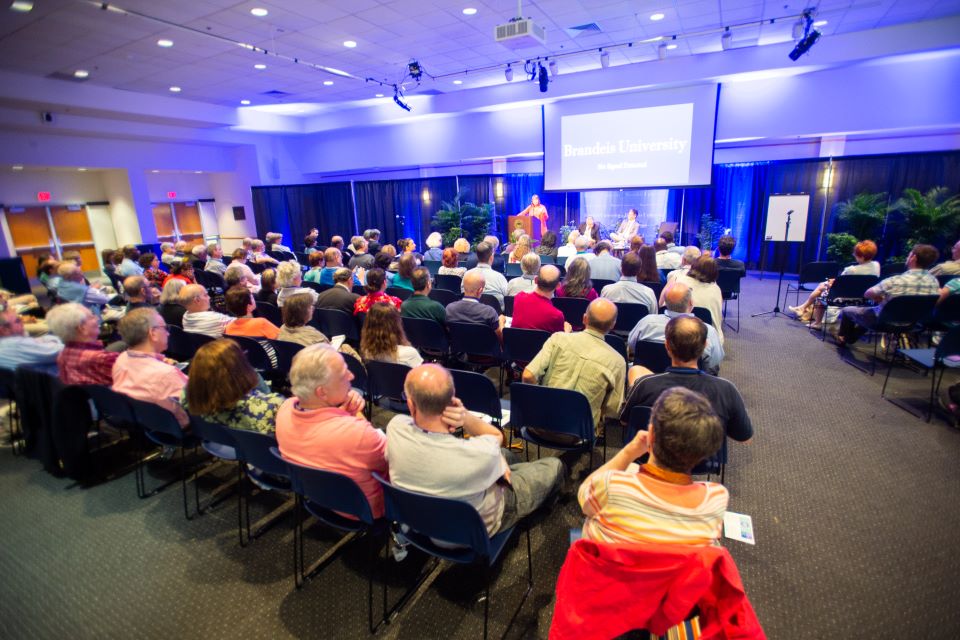 room filled with seated guests looking toward the front of the room