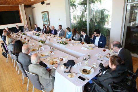 Group of people seated at a long dining table