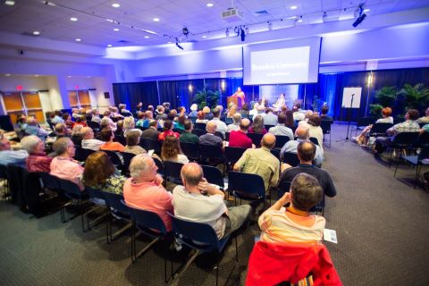 View from the back of room filled with audience