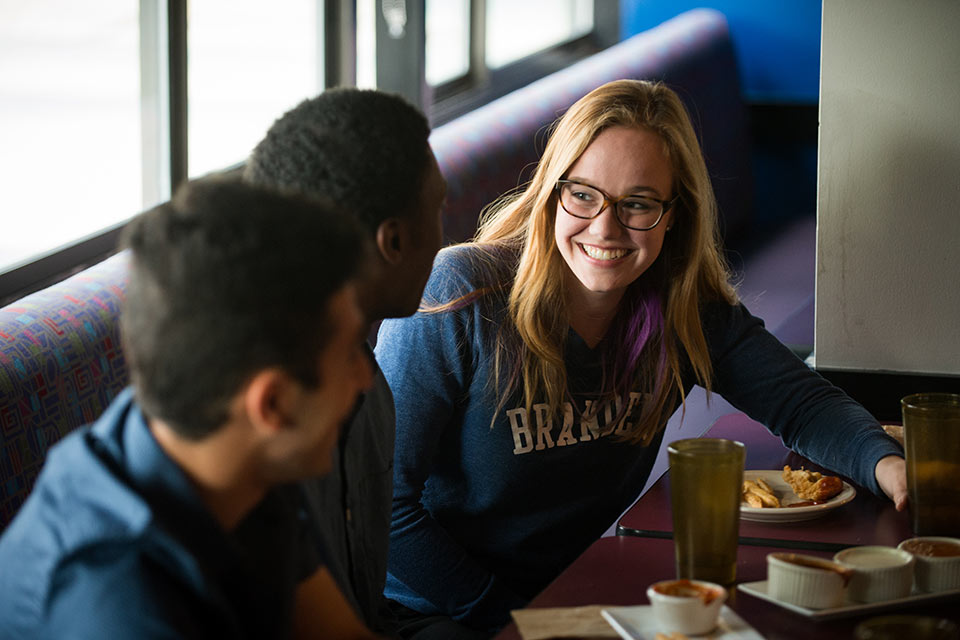 Students enjoying a meal together in a dining hall