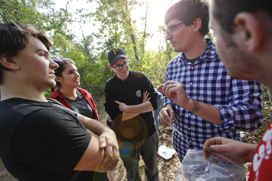 Professor Parno talks to students at a wooded dig site in Concord, Massachusetts