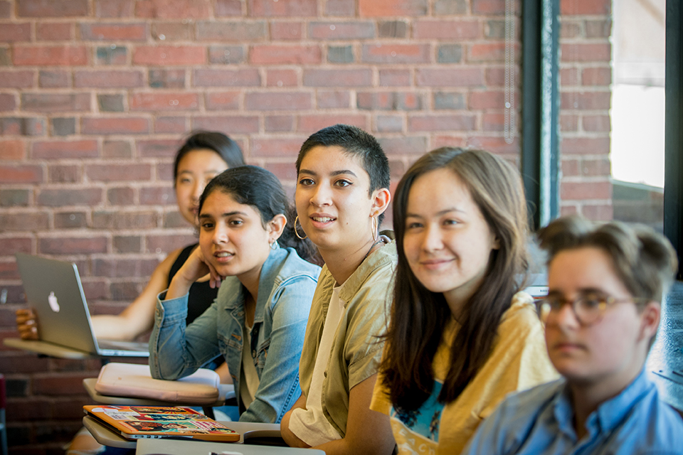 A row of attentive students in class