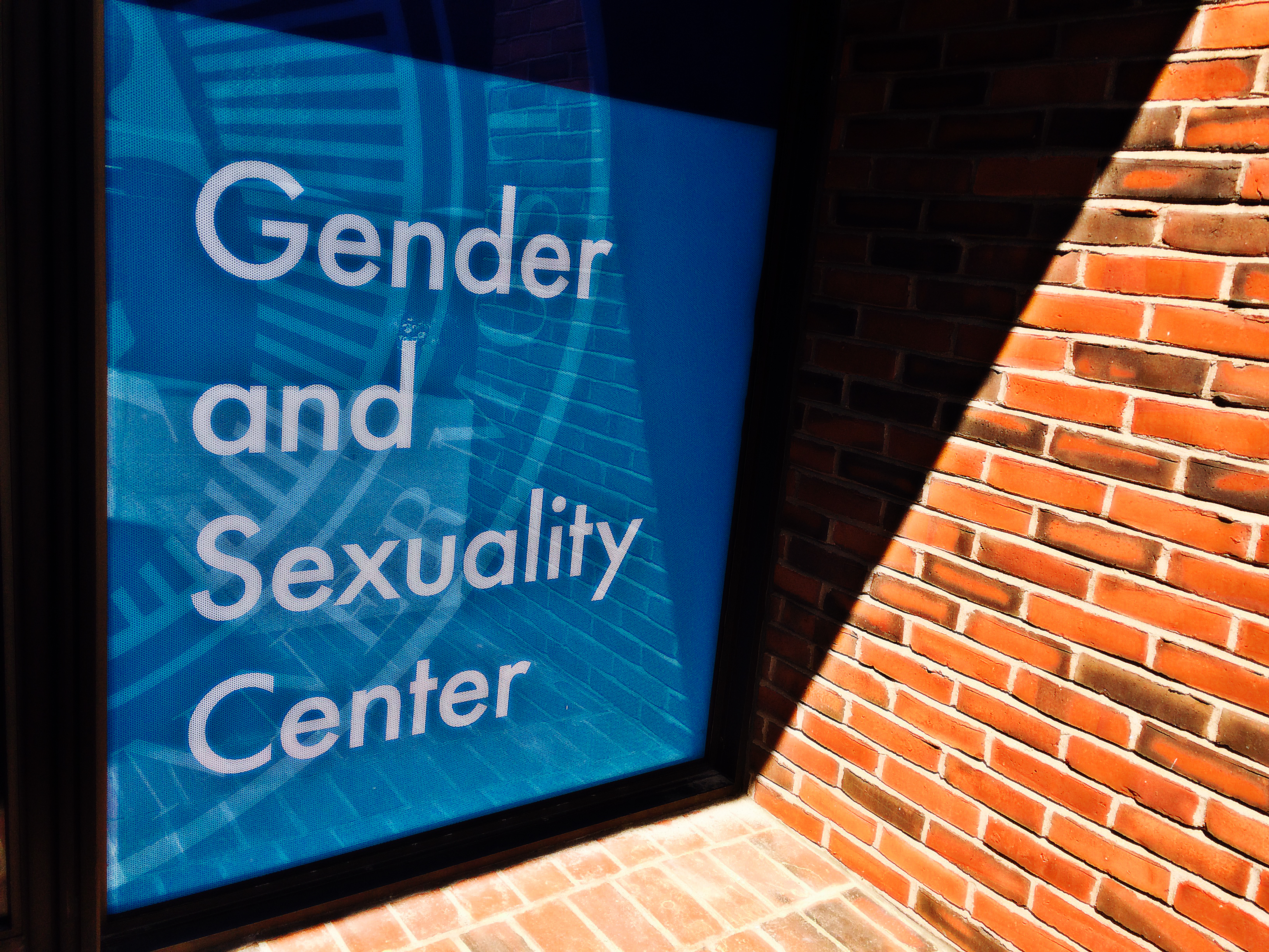 Sign for the Gender and Sexuality Center hanging in a window
