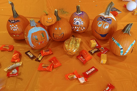 Decorated mini pumpkins and candy