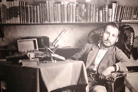 Man seated in a library. See caption for text on image.