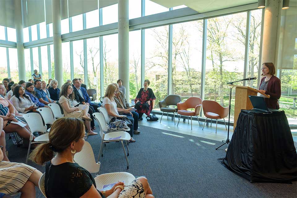 Audience and a speaker at the WGS Commencement Reception