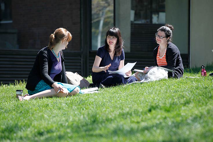 ChaeRan Freeze talking with students on the grass