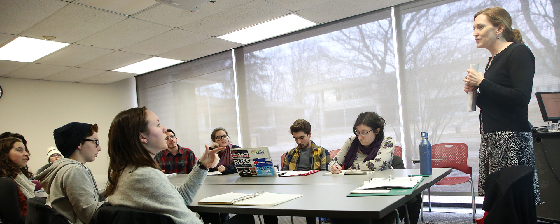 Prof. Jill Greenlee lecturing to a table of students