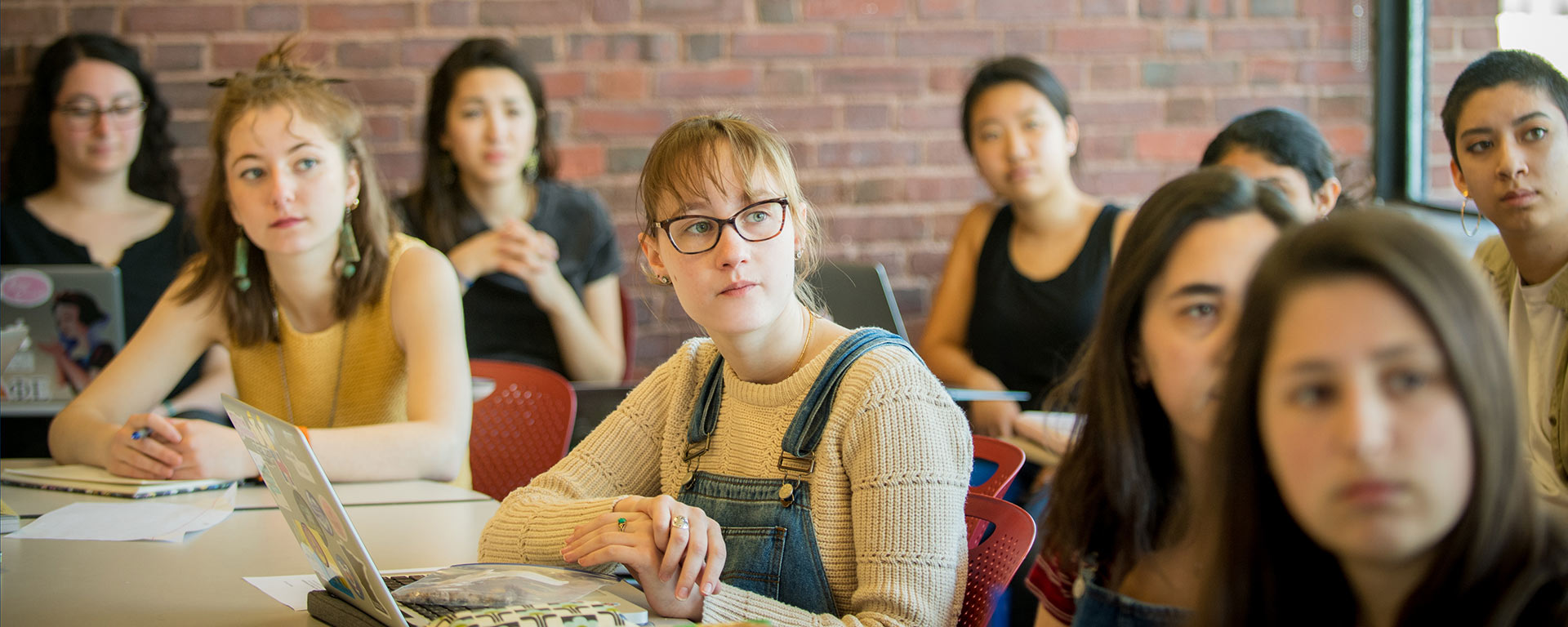 Students in discussion sitting at a classroom table