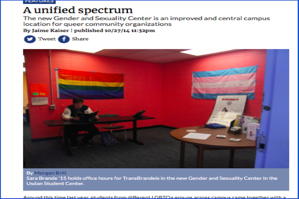 a screenshot of a feature article by Jaime Kaiser from the Justice website titled "A unified spectrum." There is a photo captioned "Sara Brande '15 holds office hours for TransBrandeis in the new Gender and Sexuality Center in the Usdan Student Center." The photo shows a room with red walls, one with the gay pride flag and one with the trans pride flag, and Sara sitting at a desk. 