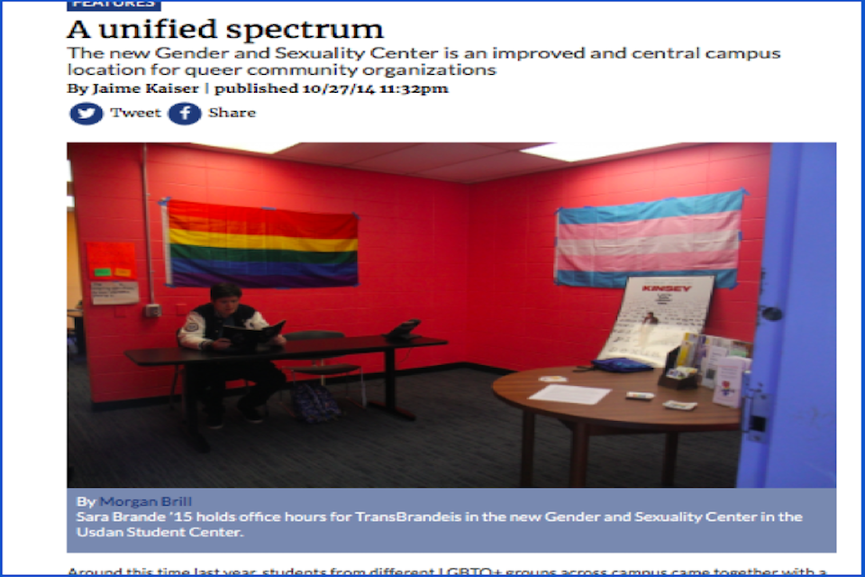 a screenshot of a feature article by Jaime Kaiser from the Justice website titled "A unified spectrum." There is a photo captioned "Sara Brande '15 holds office hours for TransBrandeis in the new Gender and Sexuality Center in the Usdan Student Center." The photo shows a room with red walls, one with the gay pride flag and one with the trans pride flag, and Sara sitting at a desk.