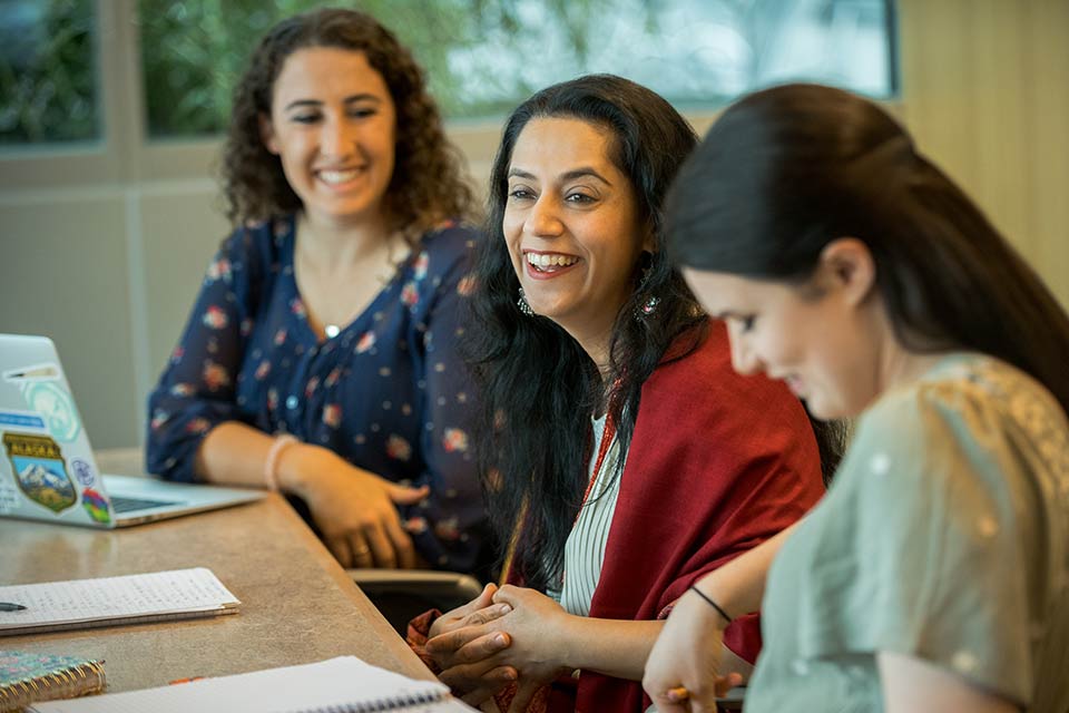 Professor Harleen Singh and two students in a classroom