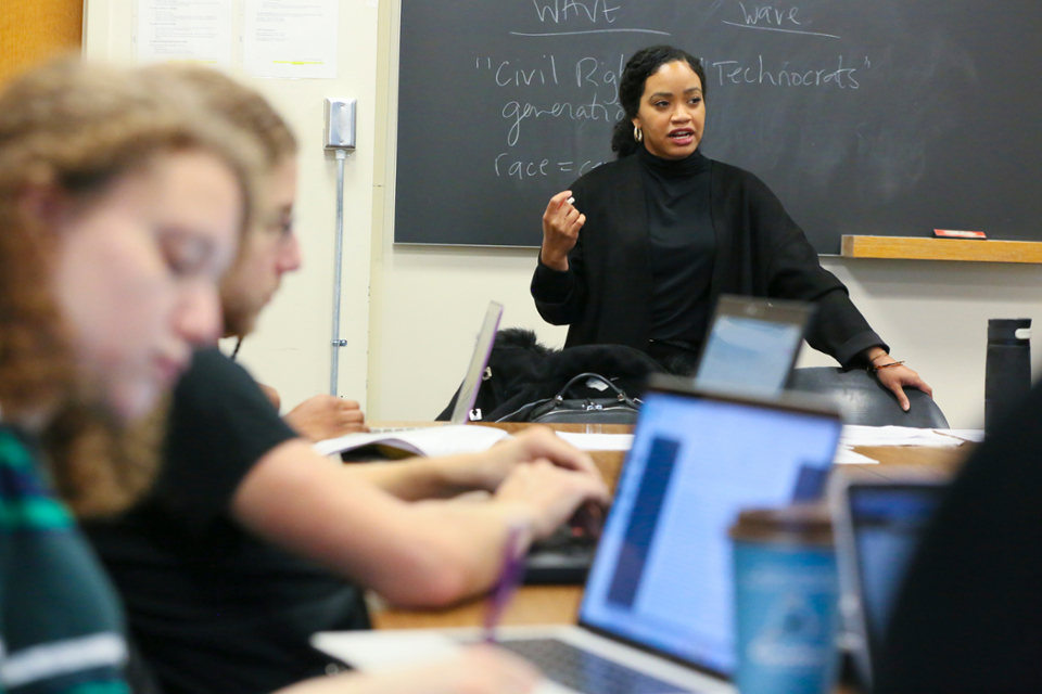 faculty member teaching in front of a board