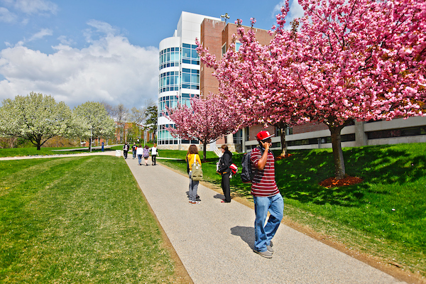student walking on campus in spring