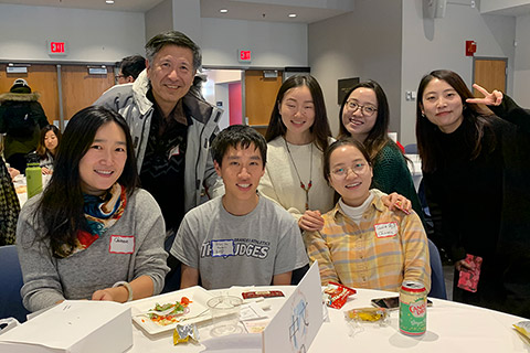 students seated at chinese-language table