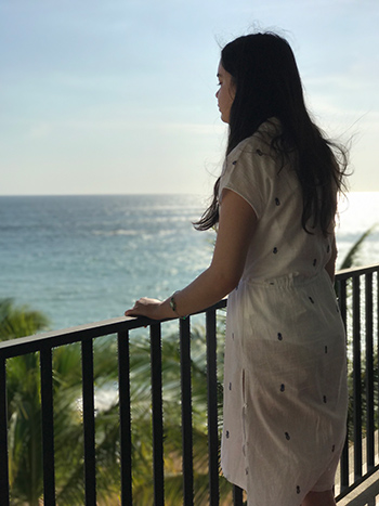 woman looking out from balcony