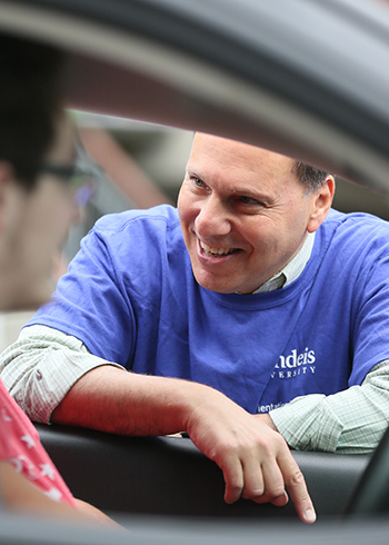 president liebowitz greets parent of incoming student in her car