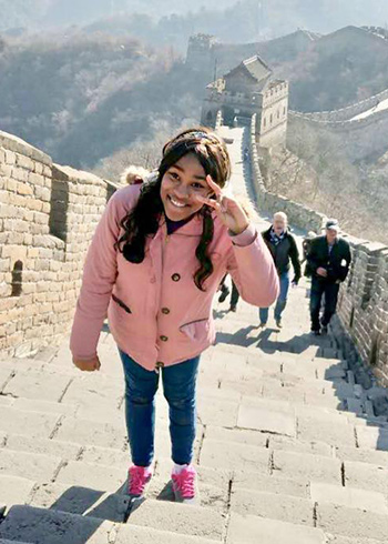 minnie norgaisse walks the steps of the great wall of china