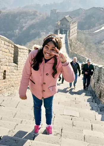 Minnie Norgaisse walks the steps of the great wall of china
