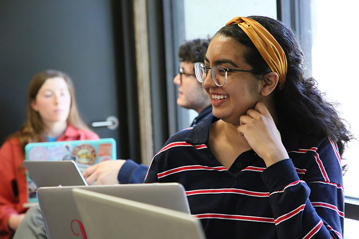 A student smiles in a classroom