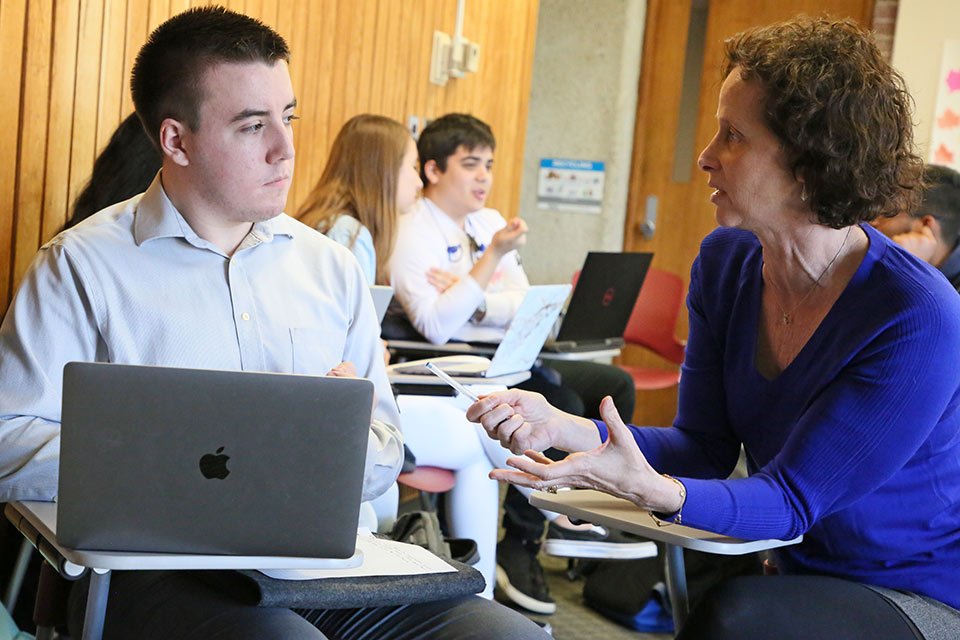 Lisa Rourke assisting a student in a classroom