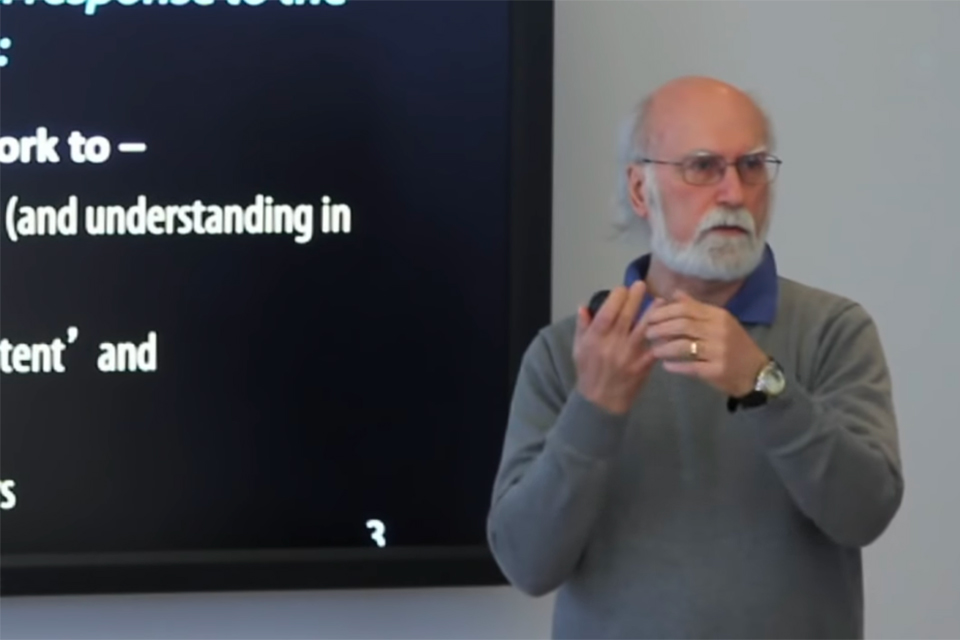 faculty member presenting in front of screen