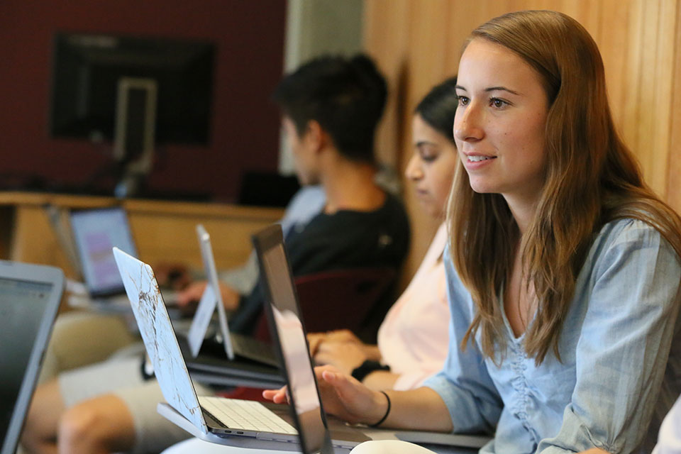 A student at a laptop in class