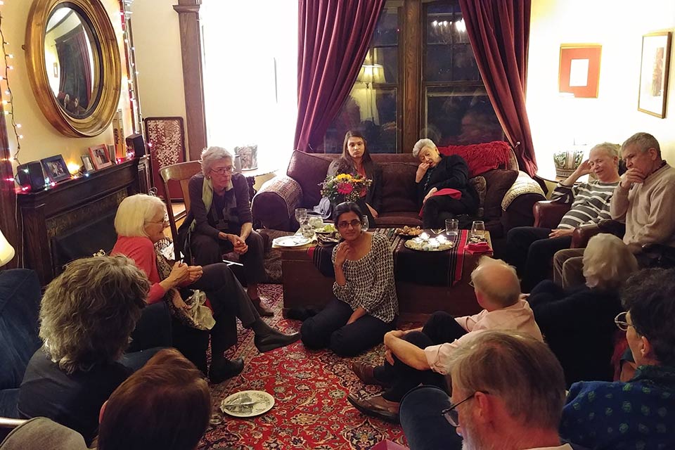 Group of people seated in a room talking