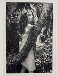 women in white dress standing in trees