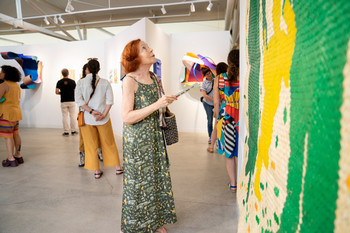 visitor to the Kniznick gallery looking at art on the wall