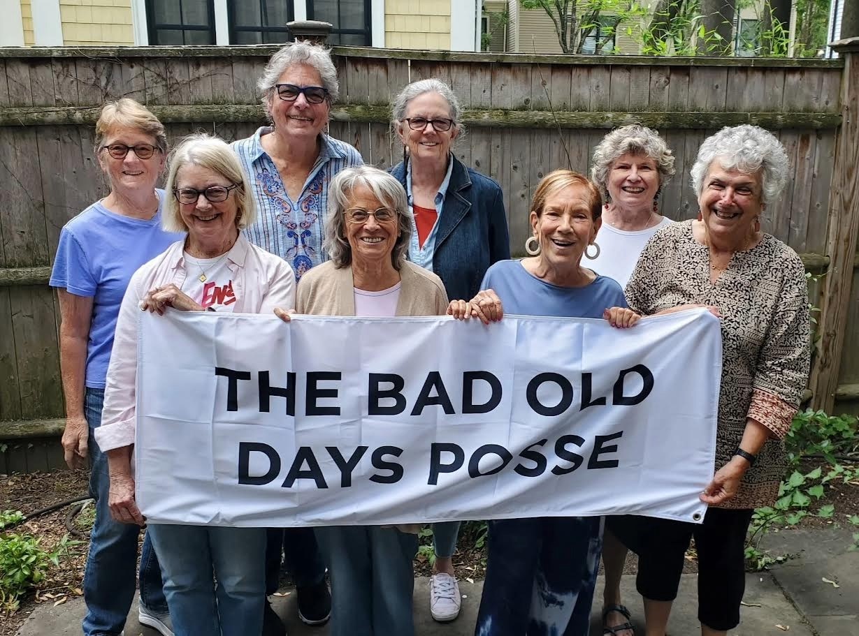 original members of Bad Old Posse standing with banner