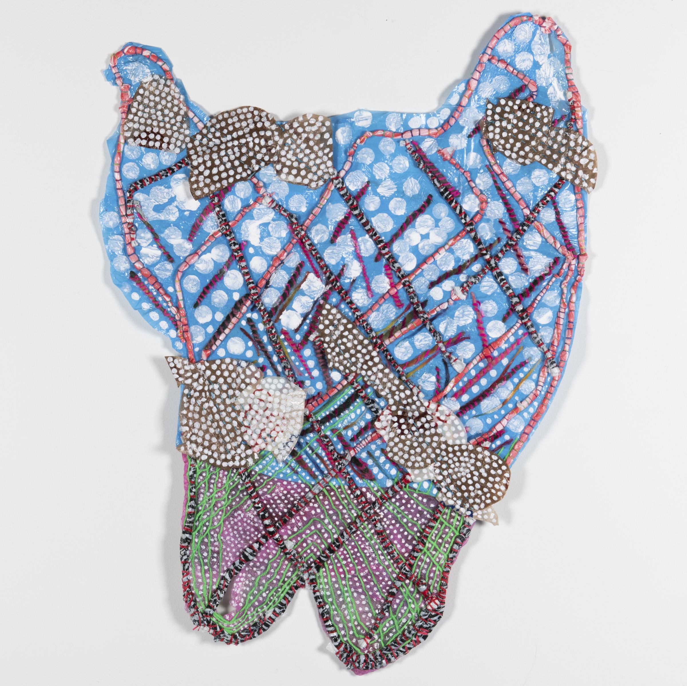 A vibrantly colored work by J Stoner Blackwell in which they have applied textile and paint to a plastic bag. 